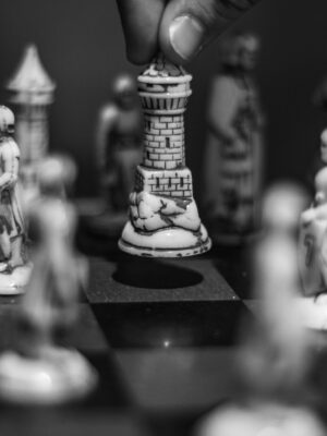 Black and white chess scene with a rook being strategically moved on the board.